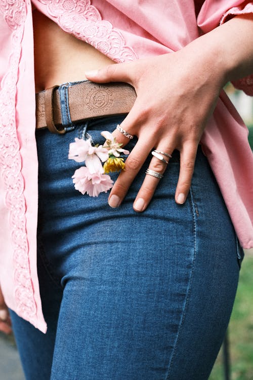 Close up of Woman Hand with Flowers Petals