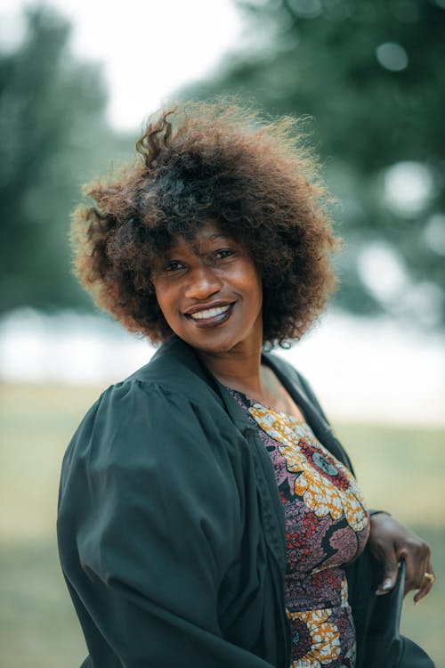 Woman with Afro Hairstyle Posing in a Park