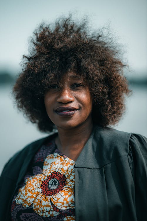 Portrait of a Woman with Tousled Afro Hair, Wearing a Floral Textile