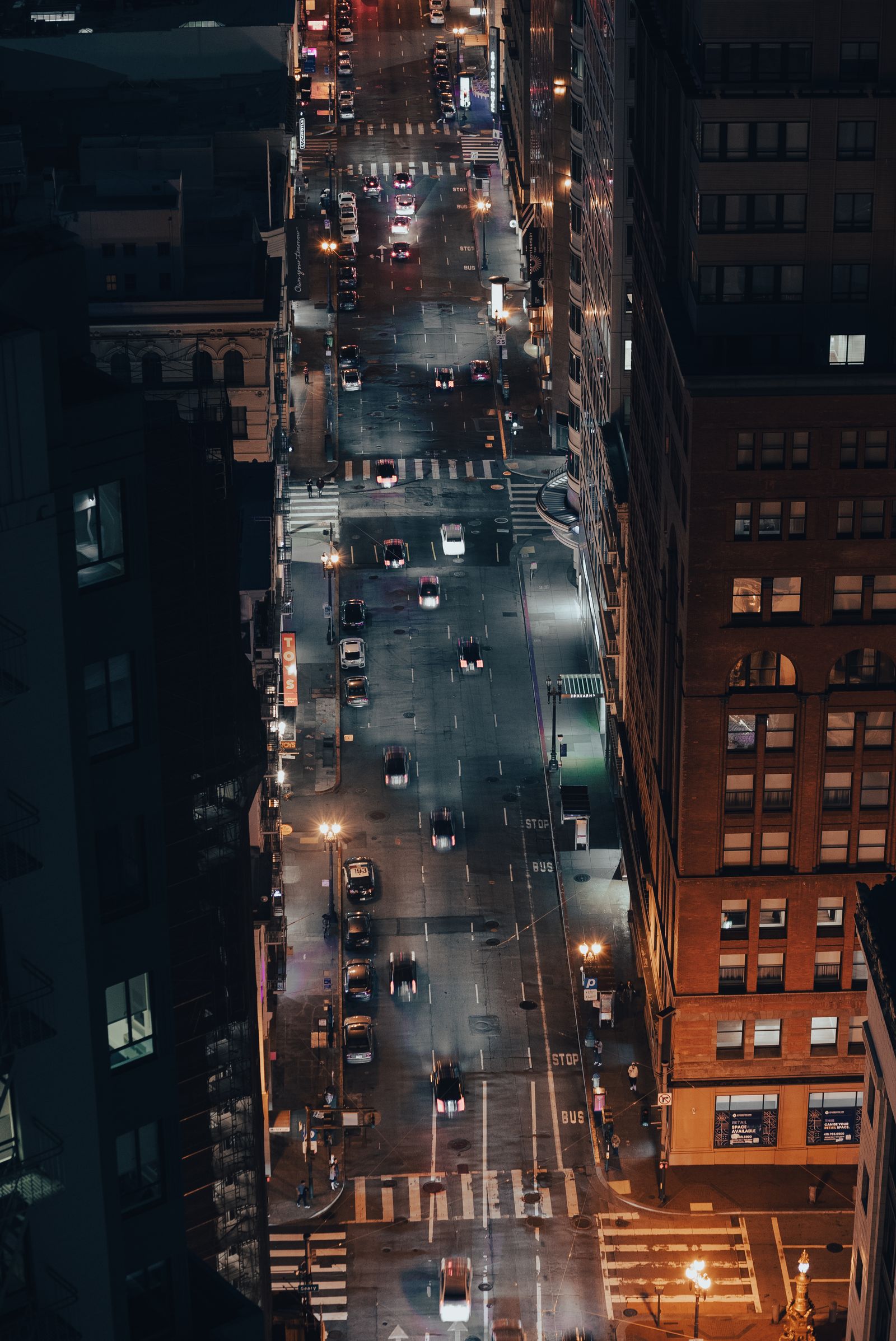 A busy city street at night full of traffic and noise