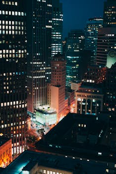 Stunning cityscape at night showcasing illuminated skyscrapers in a bustling urban environment.