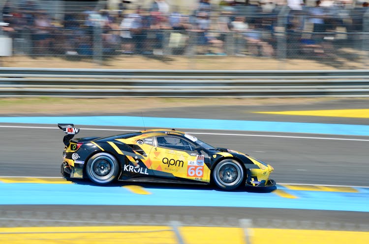 Black And Yellow Car Racing On Track