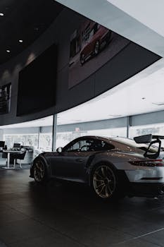 A sleek luxury sports car displayed in a modern car showroom.