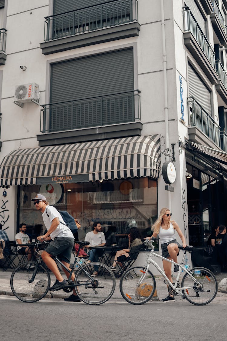 Woman And Man On Bicycles On Street