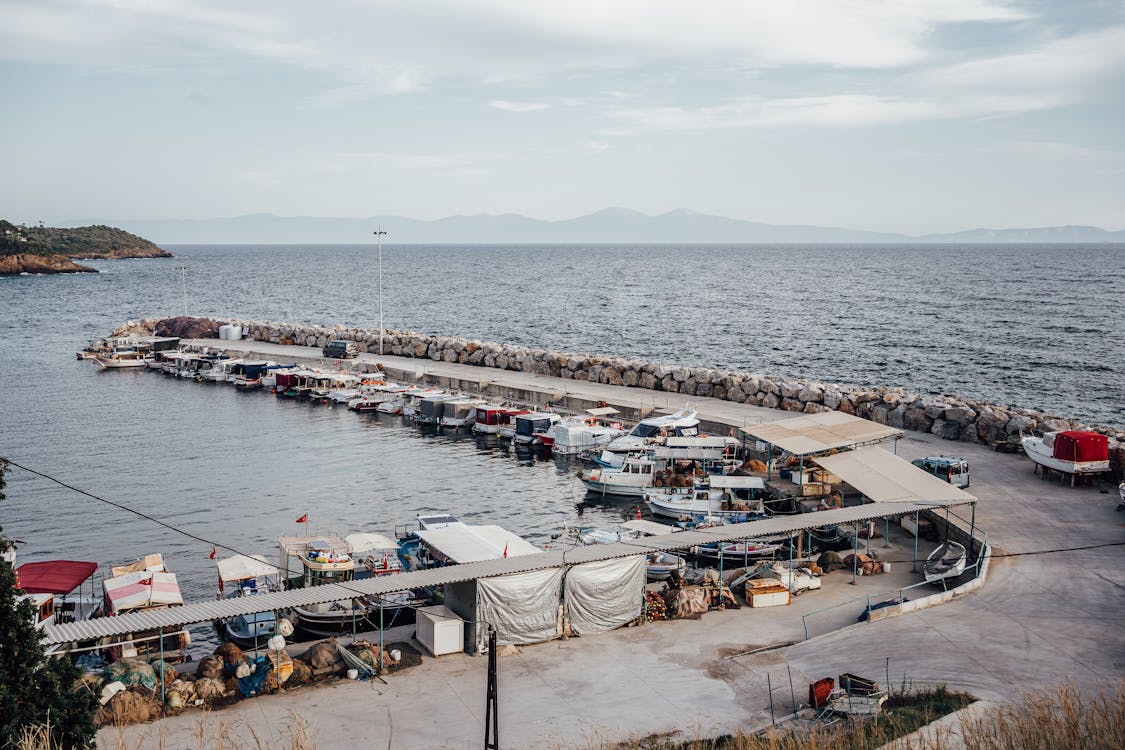 Moored Motorboats by Pier on Sea Shore