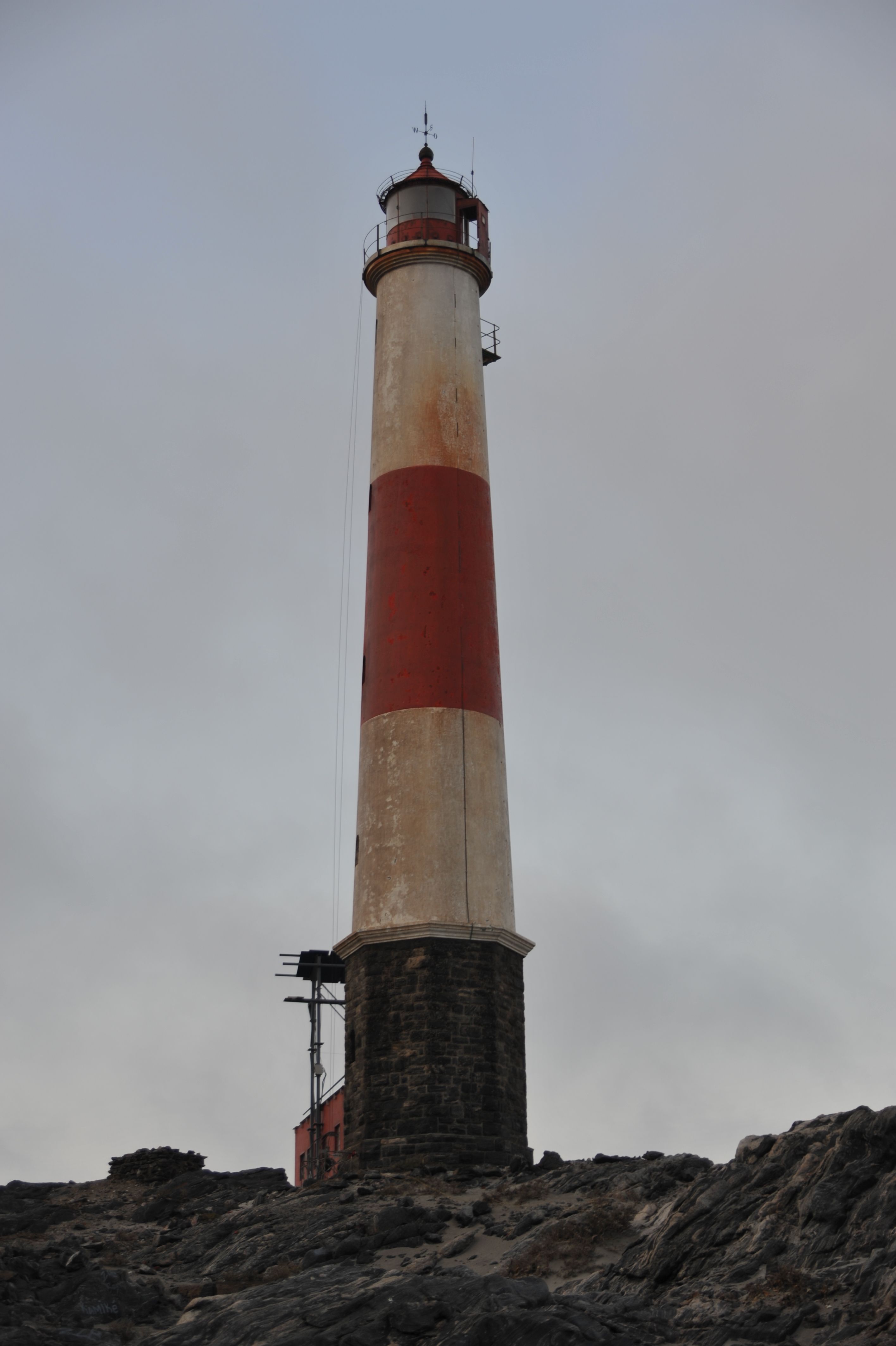 Scenic view of the iconic Diaz Point lighthouse in Namibia under an overcast sky.