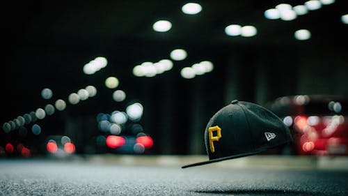 Black and Yellow P Cap Hanging in the Air