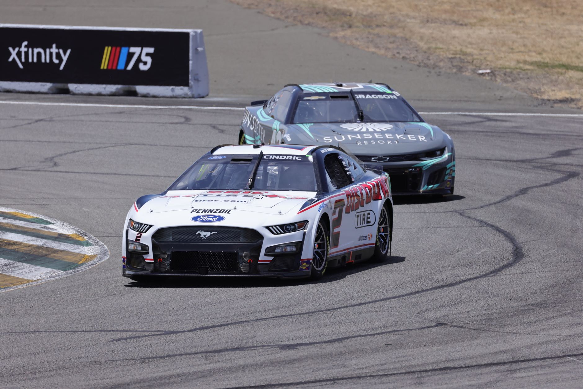 High-speed Ford and Chevrolet cars racing on the thrilling NASCAR circuit.