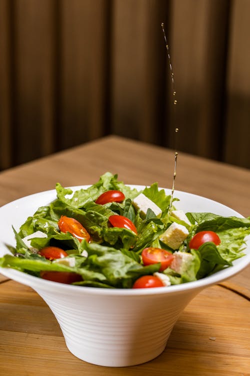Olive Oil Dropping on Salad