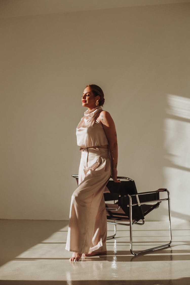 Photo Of An Elegant Barefoot Woman Standing In A Room