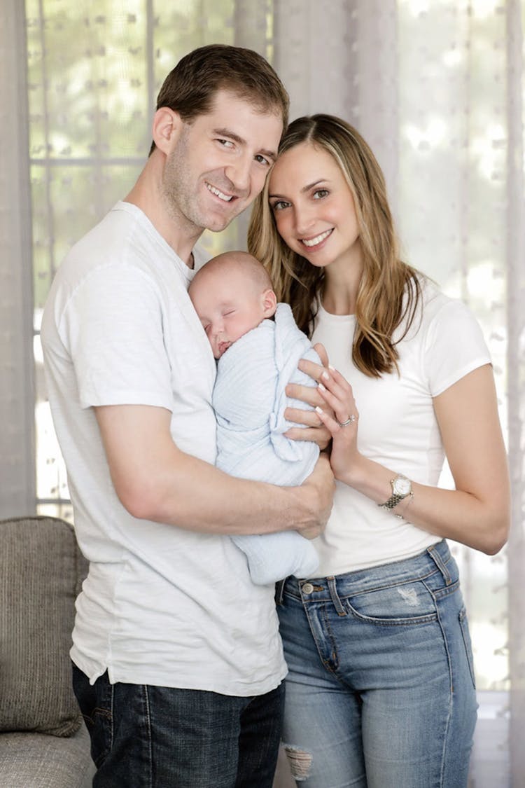 Parents Holding A Newborn Baby