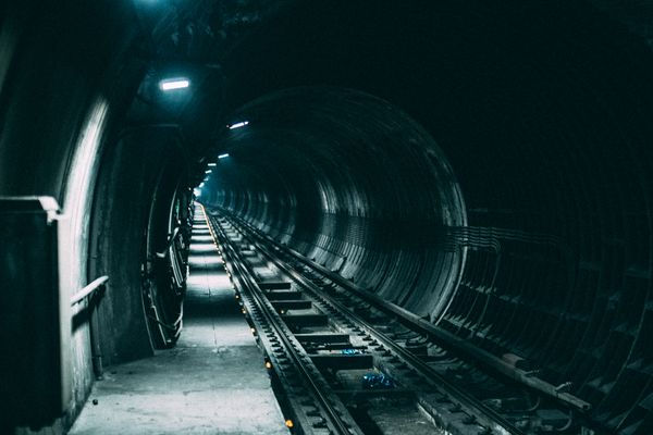 A dark railway tunnel receding into shadow — photo by Kaique Rocha on Pexels