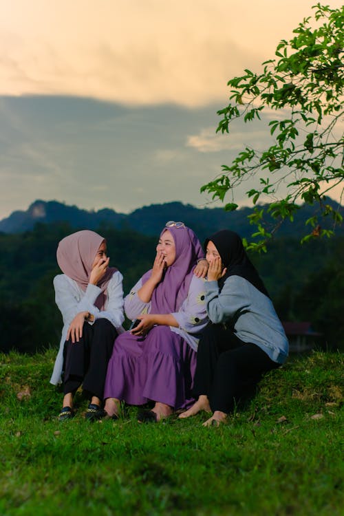 Women in Hijabs Sitting and Gossiping