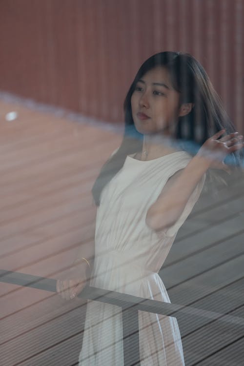 Free A Woman Standing Behind a Window  Stock Photo