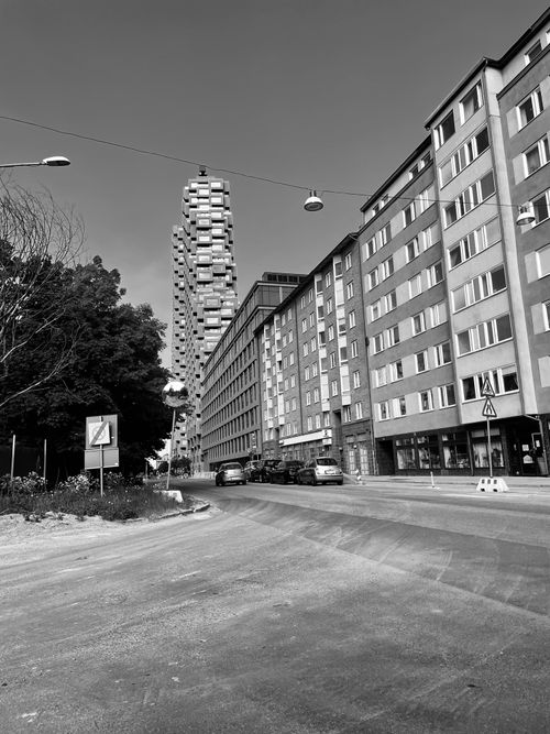 Free Black and white photo of a city street with modern buildings and urban landscape. Stock Photo