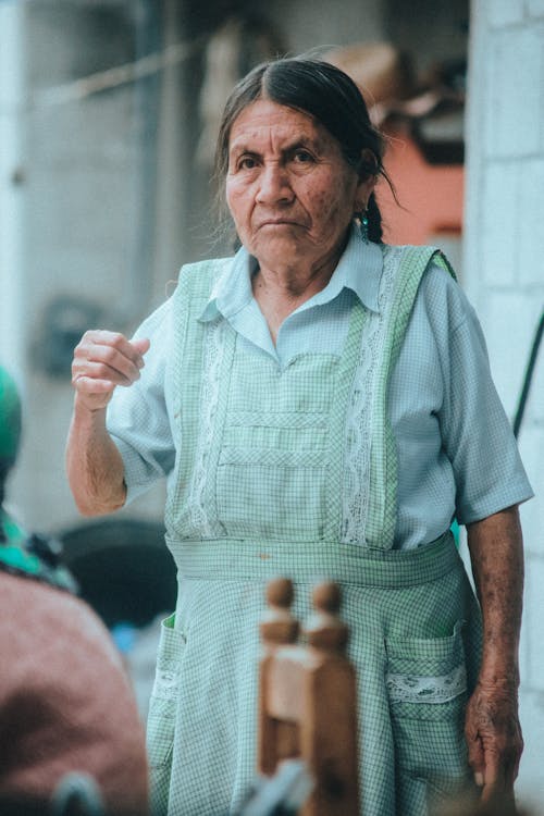 Elderly Woman in Green Apron