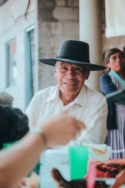 Smiling Man in Shirt and Hat