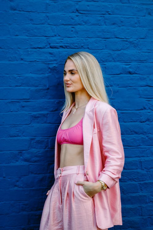 Blonde Woman Standing and Posing in Pink Clothes
