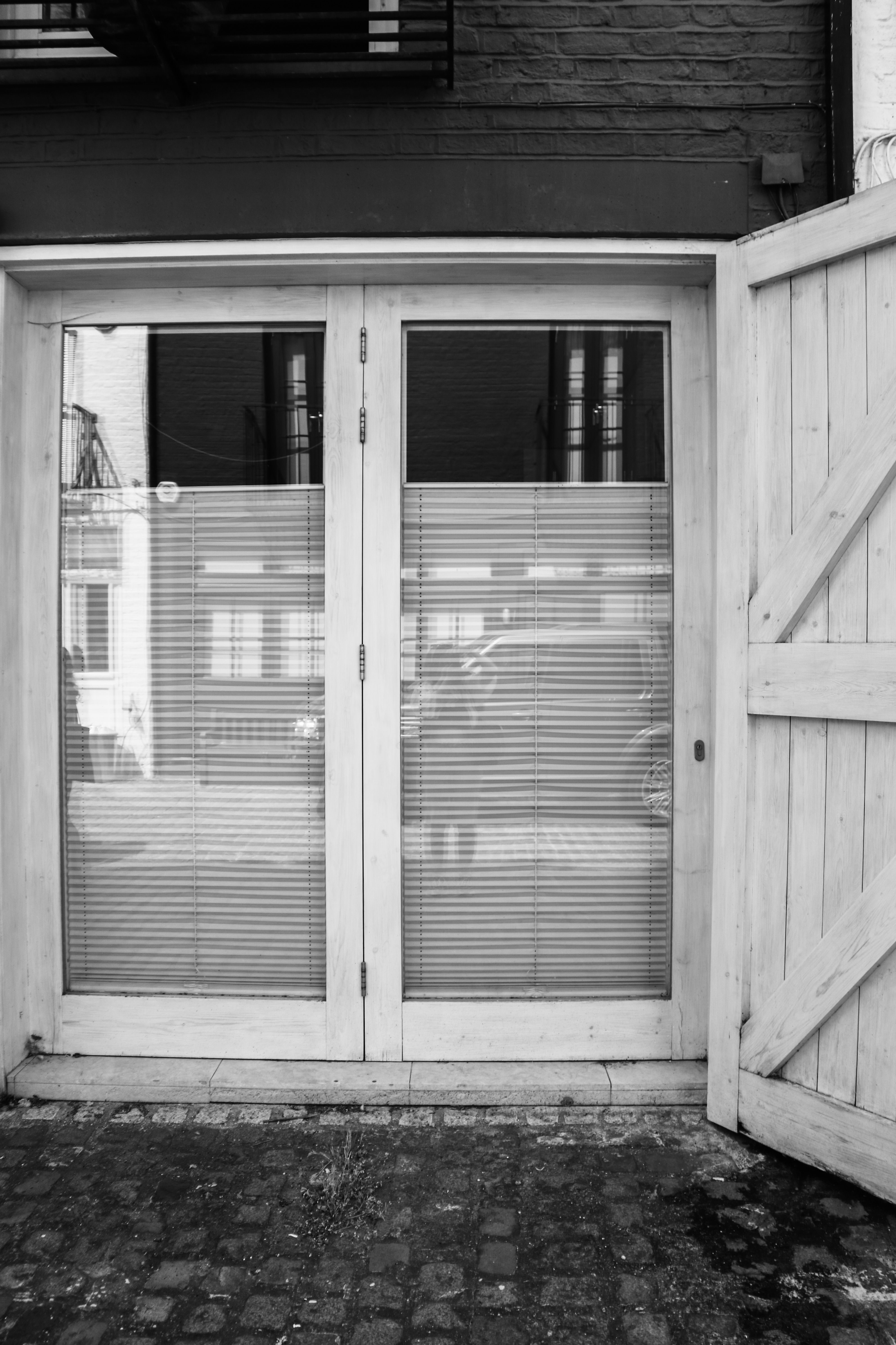 Black and White Picture of an Entrance with Glass Door · Free Stock Photo