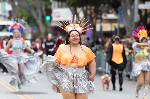 Women in Costumes Dancing on the Street during a Parade