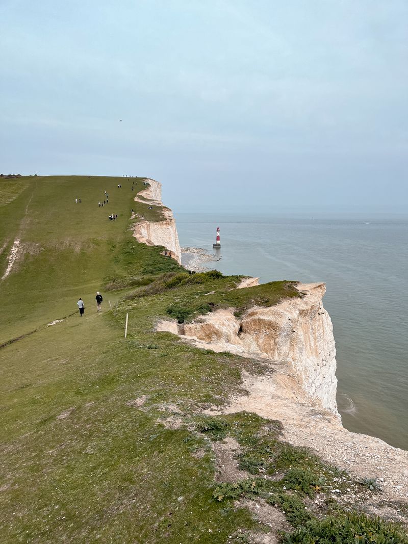 People hiking on coastal cliffs by the sea