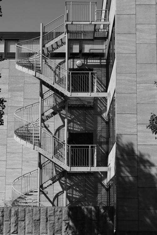 Free Black and white photo of a spiral fire escape on a Jönköping building facade. Stock Photo