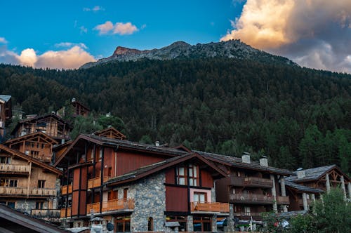 Brown Houses Beside Mountain Under Blue Sky