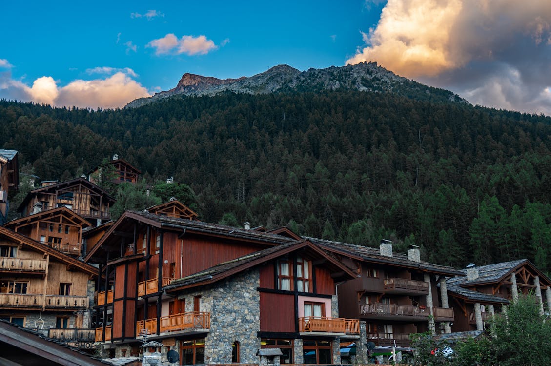 Free Brown Houses Beside Mountain Under Blue Sky Stock Photo