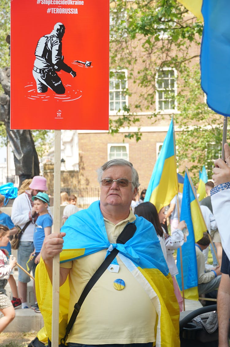 Man With Banner And Flag Of Ukraine