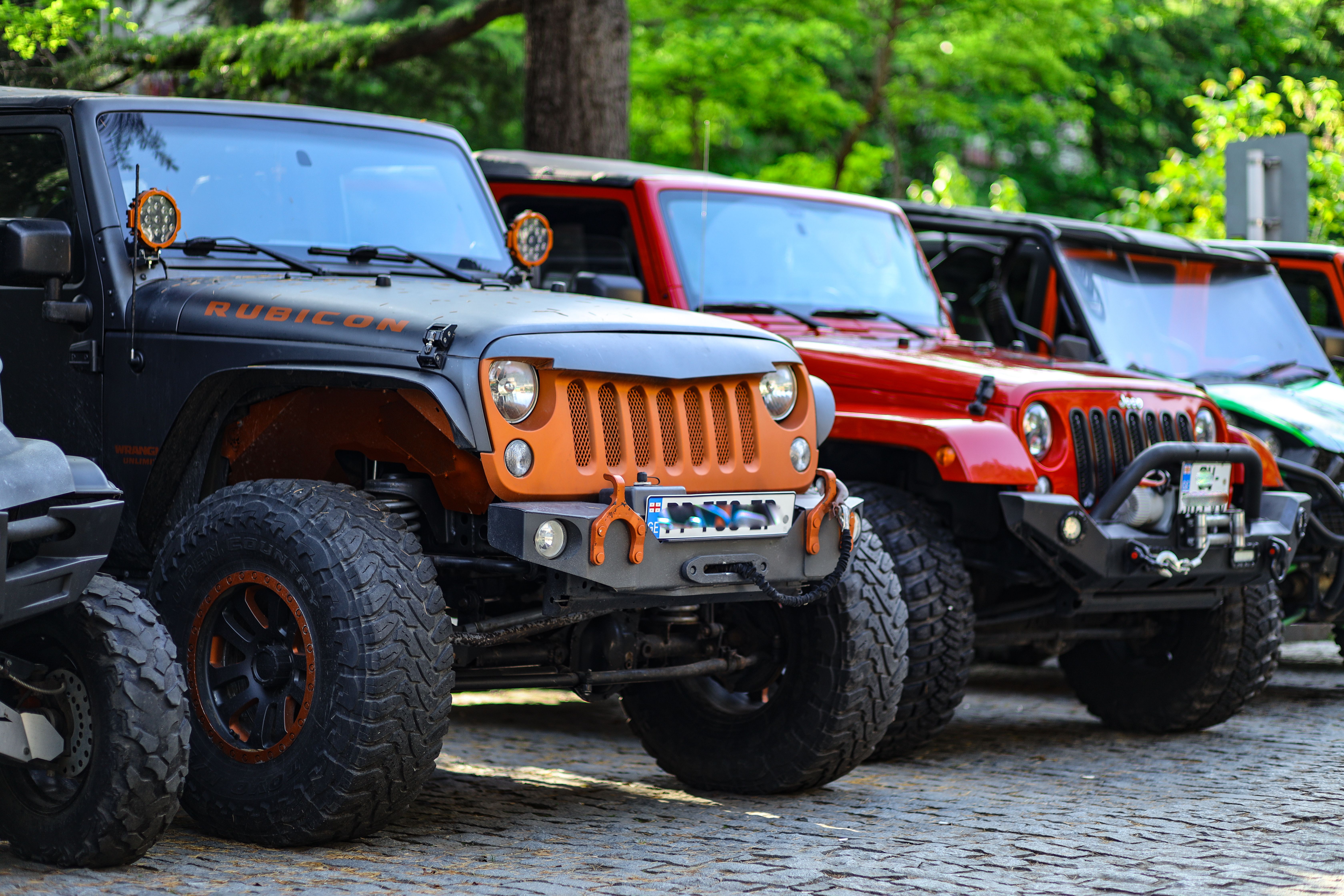 A Row of Off Road Cars Parked on the Street · Free Stock Photo