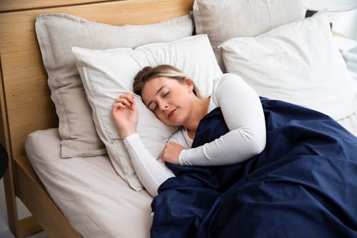 Free Young Woman Sleeping in Bed  Stock Photo