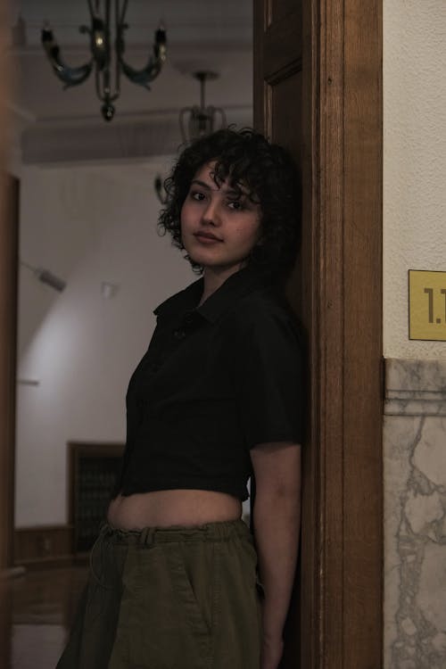 Pretty Brunette Leaning on a Doorway