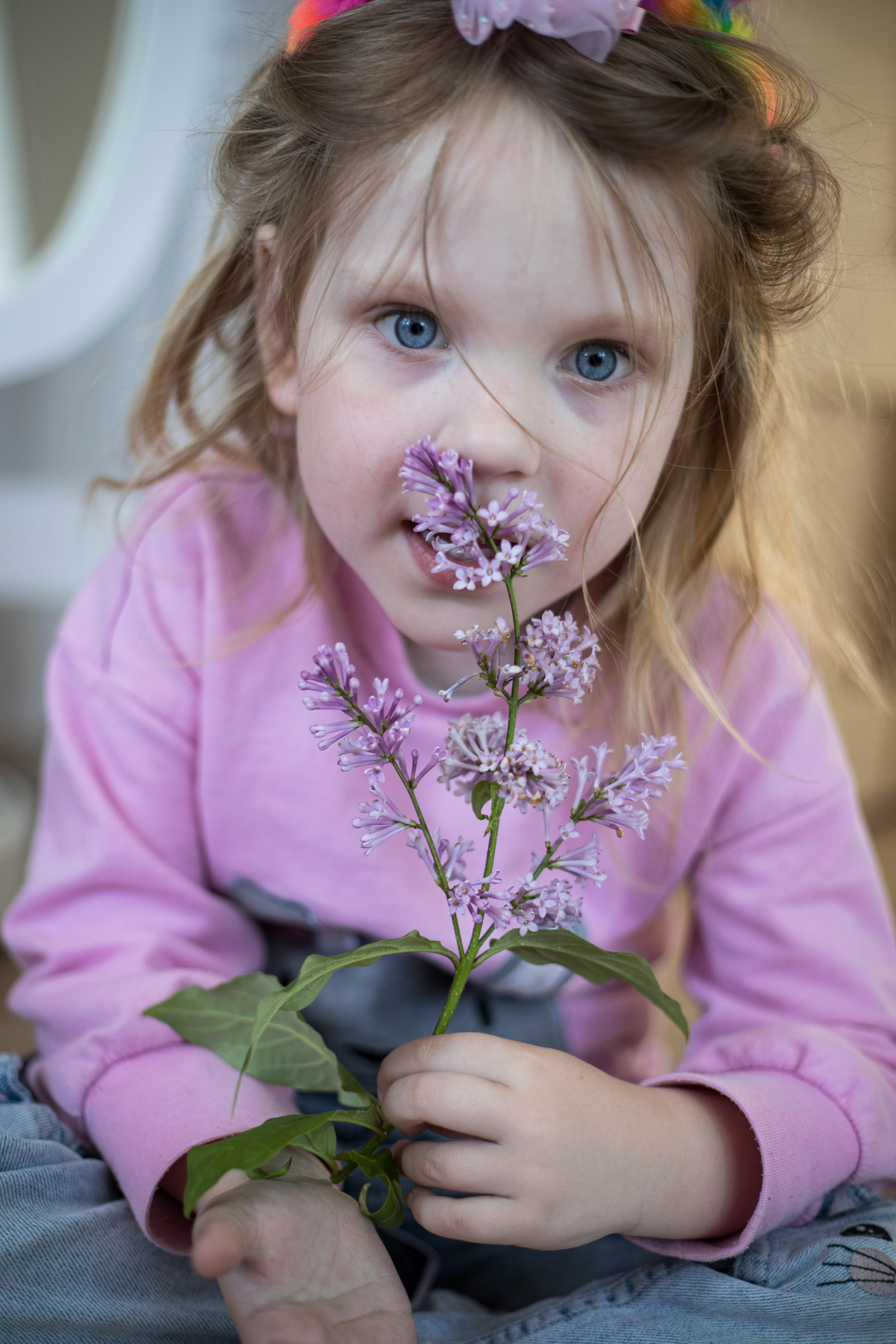 girl holding flowers over face