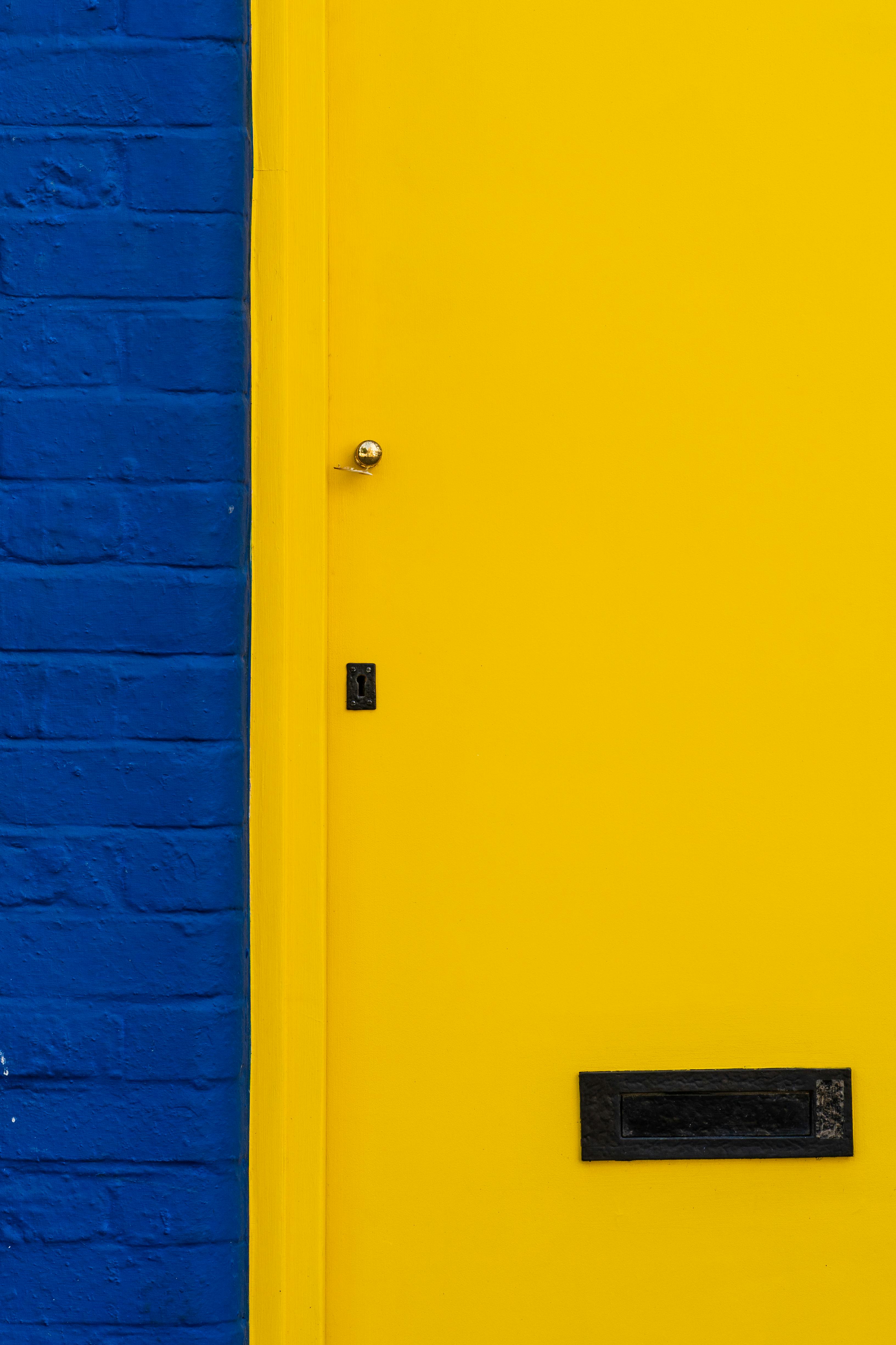 yellow door with a mail slot