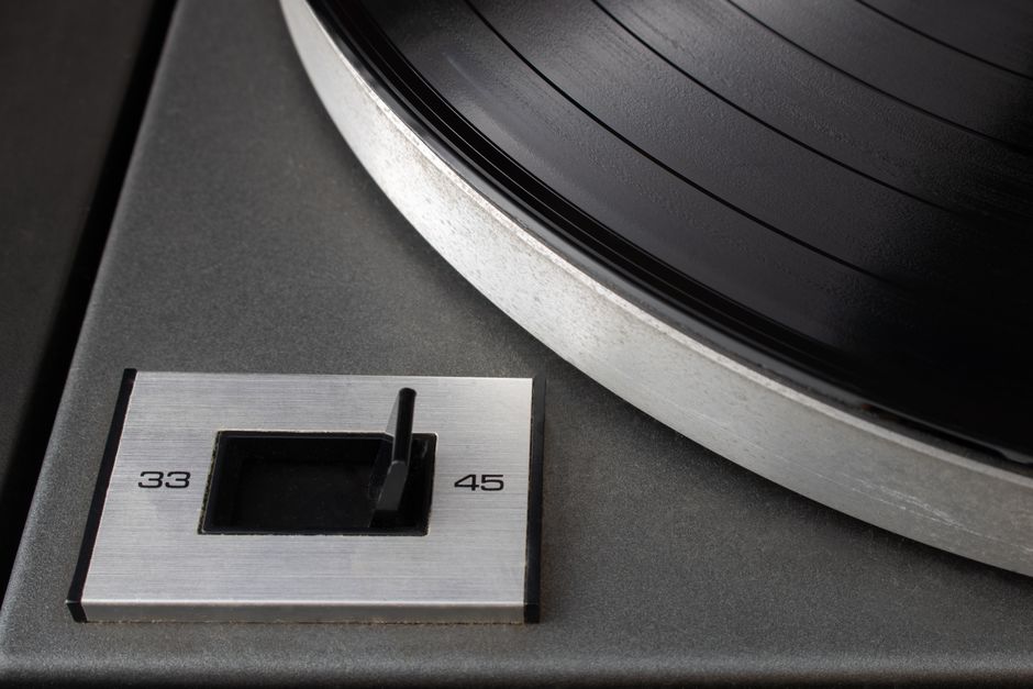 Detailed view of a classic vinyl record player with a speed selector switch.