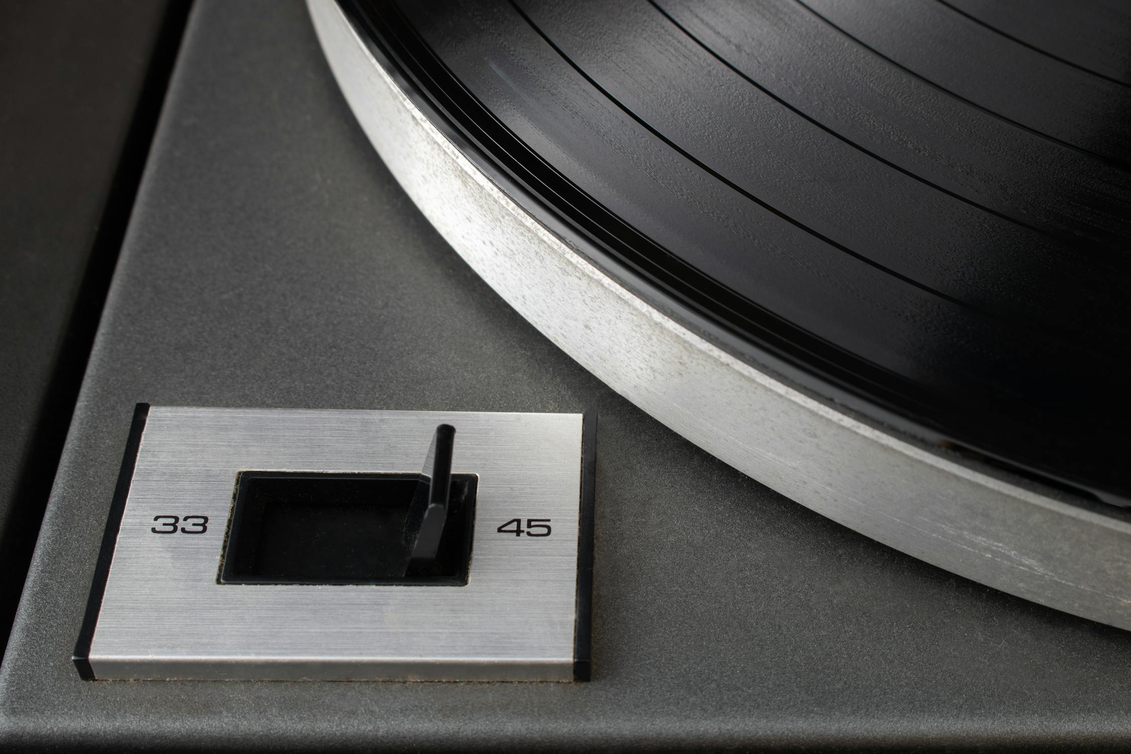 Close-up of speed rotation switch set to 45 RPM on vintage turntable ...