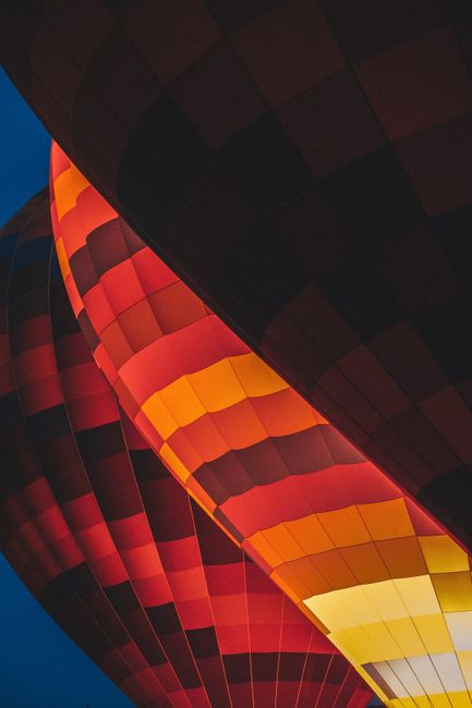 Close-up of colorful hot air balloons in Türkiye during evening twilight.