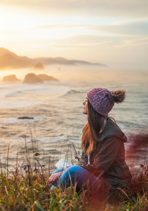 Free Woman Sitting By The Cliff Stock Photo