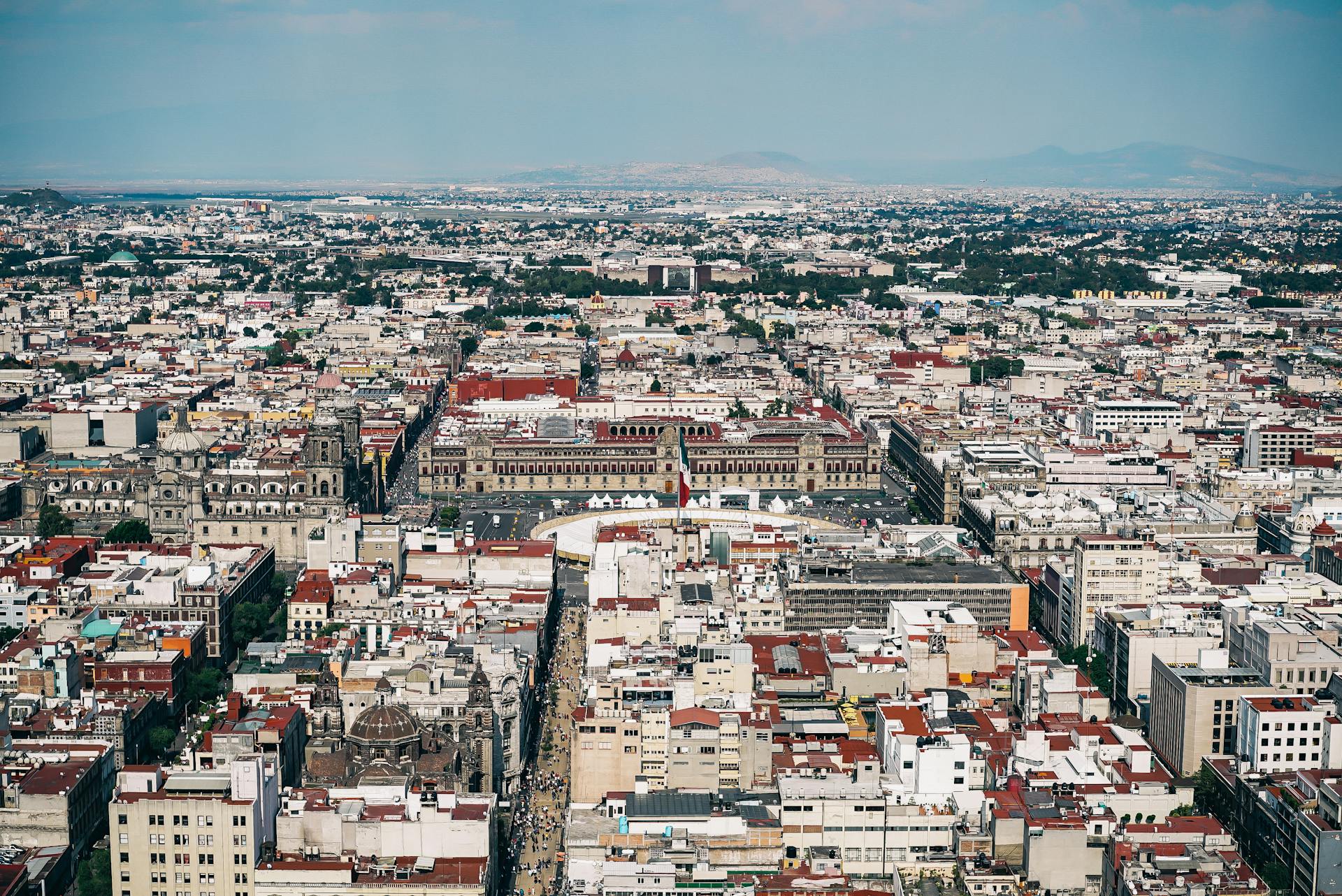 Aerial view capturing the sprawling urban landscape of Mexico City with historic architecture.