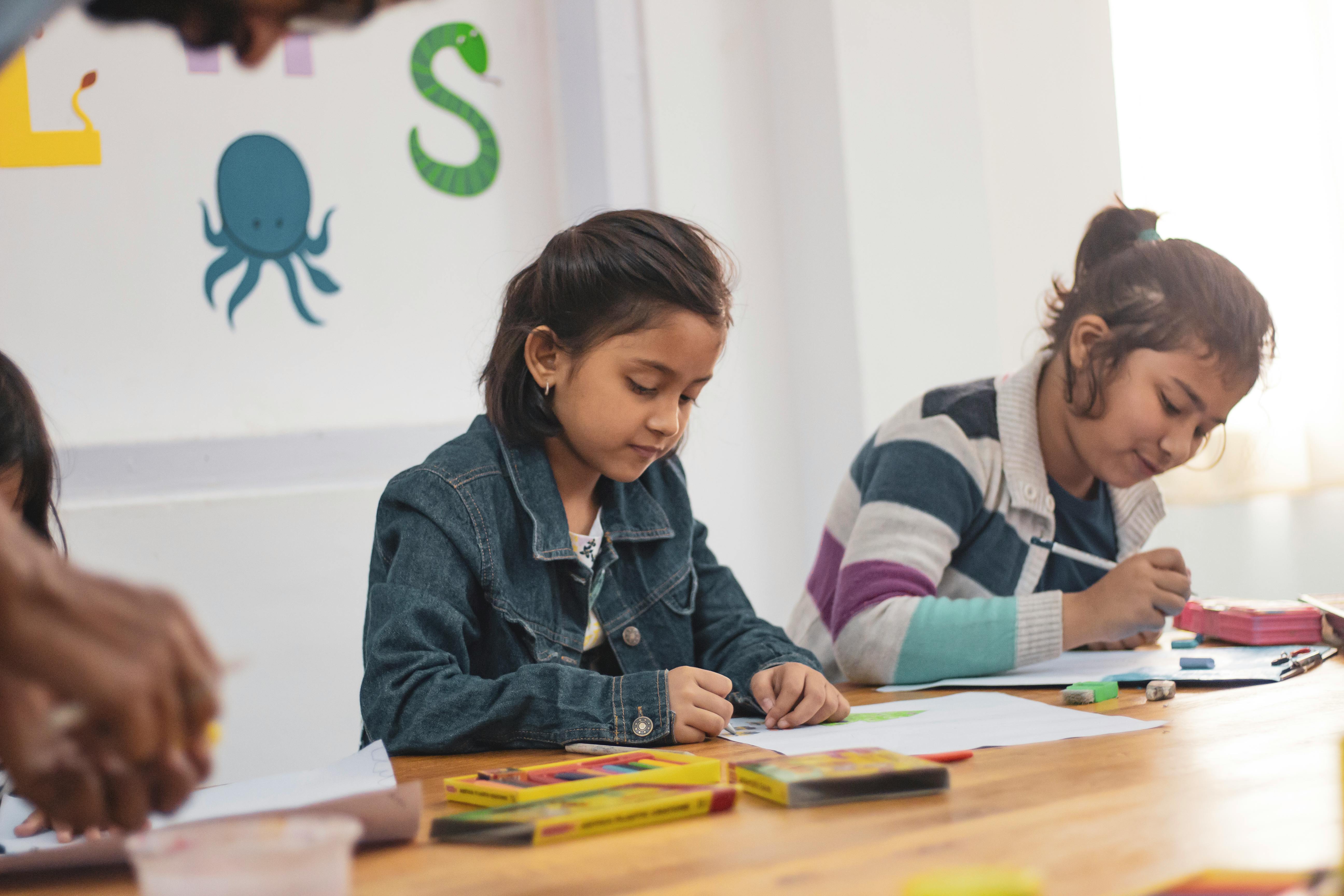 Two girls doing school works. | Photo: Pexels