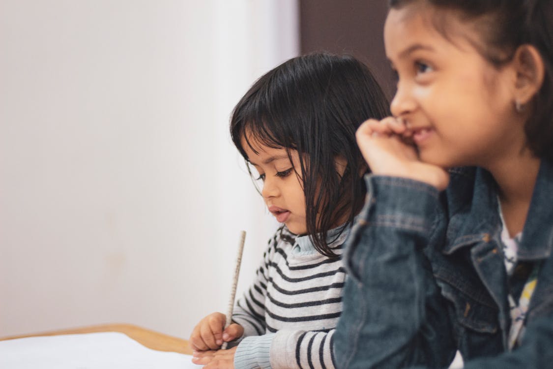 Free Two Girls Writing on Paper Stock Photo