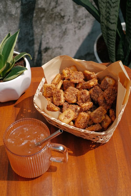 Free Crispy fried banana snacks served with a refreshing beverage on a sunny day. Stock Photo