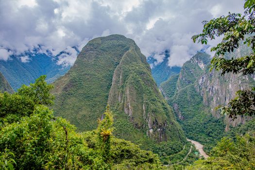 Breathtaking view of Putucusi mountain surrounded by lush greenery in Cusco, Peru.