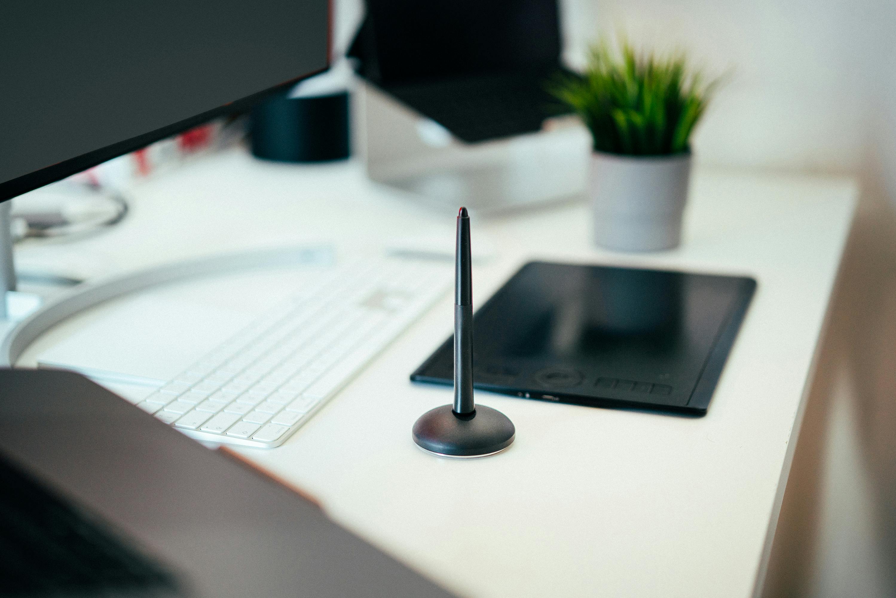 Person working in a minimalist workspace with organized office supplies and a clutter-free desk