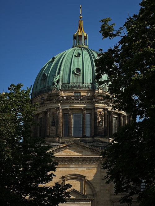 Free Stunning view of Berlin Cathedral dome amidst trees on a clear day. Stock Photo