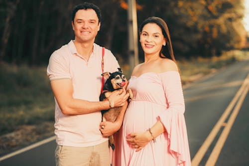 Happy Expecting Couple with Dog