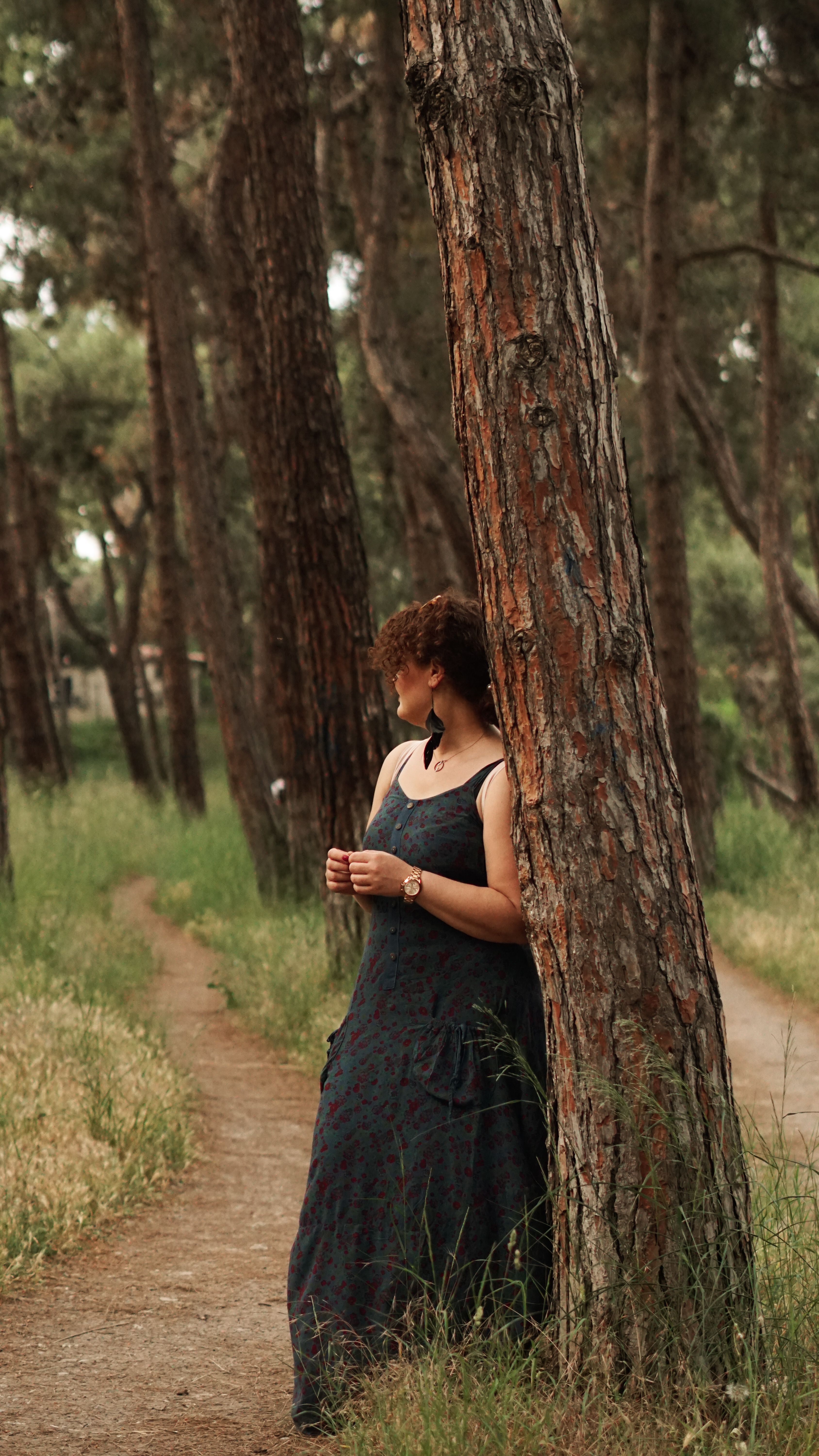 A woman in a dress is standing in the woods · Free Stock Photo