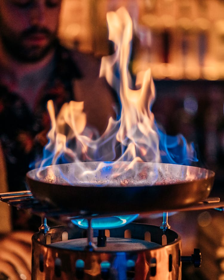 Man Cooking Food On Open Fire