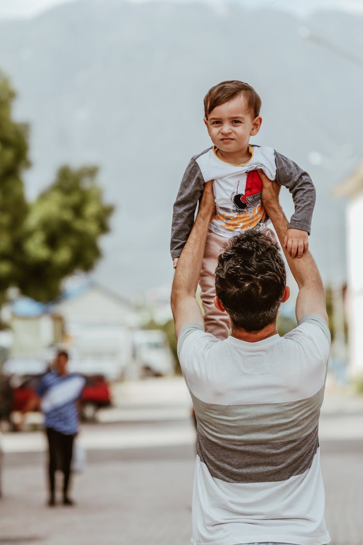 Father Lifting Up His Little Son