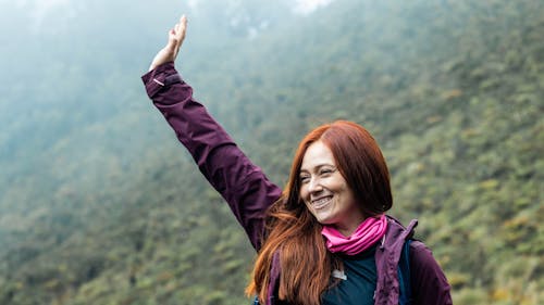 Smiling Woman Posing with Hand Raised